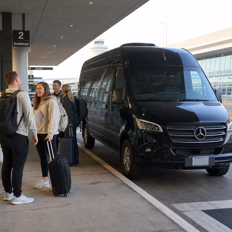Group boarding a white charter bus for Airport Transportation transportation in Dallas