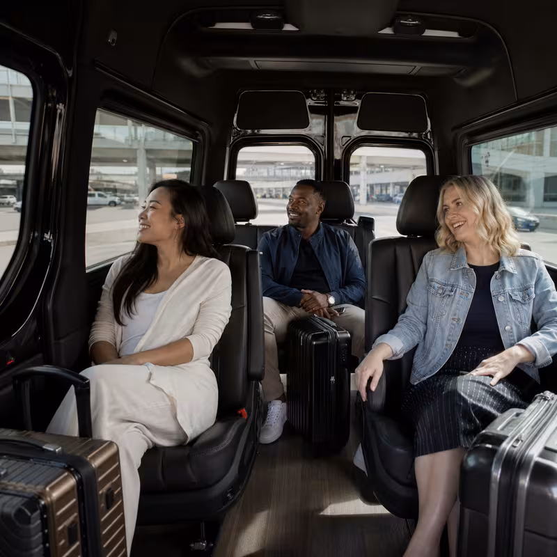 Passengers loading luggage while boarding an Dallas group shuttle