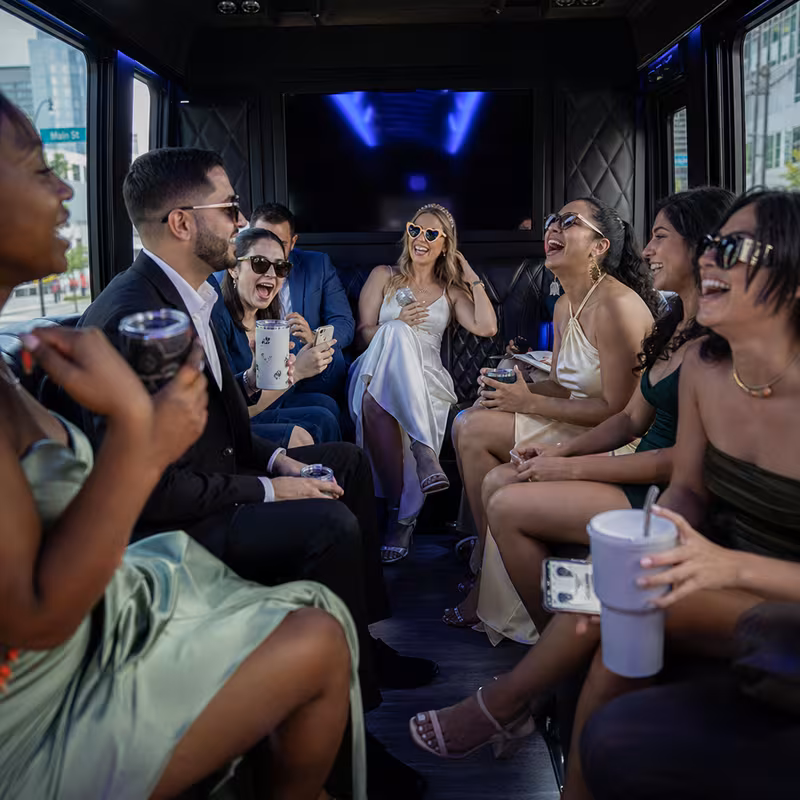 Party bus interior with wraparound leather seating and LED lighting in Dallas
