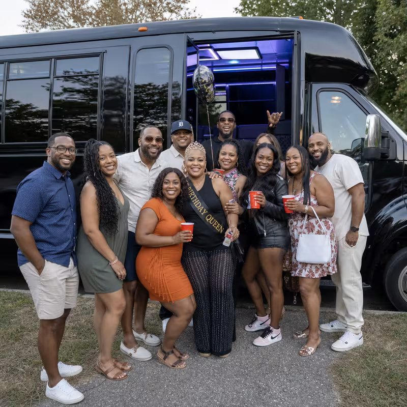 Group boarding a white charter bus for Birthday Transportation transportation in Dallas