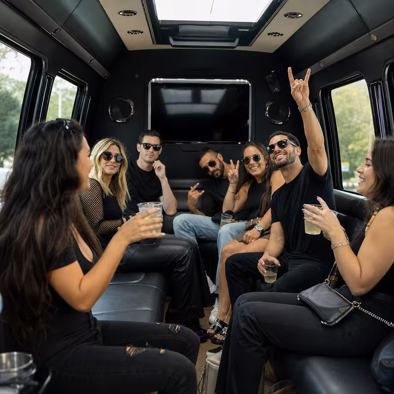 Group boarding a white charter bus for Concert Transportation transportation in Dallas