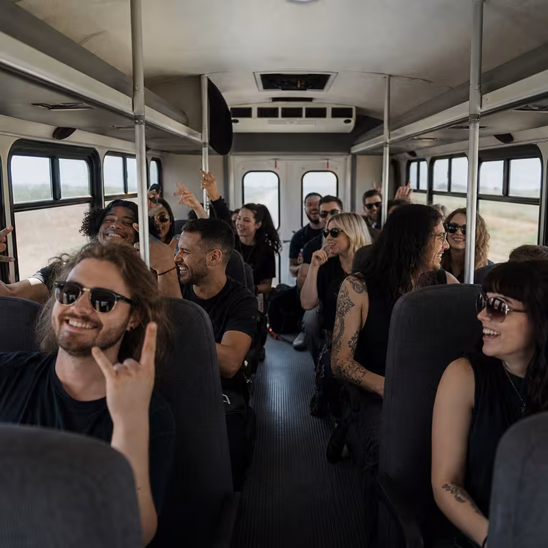 Party bus interior with wraparound leather seating and LED lighting in Dallas