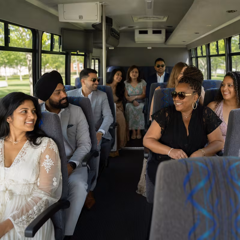 Group boarding a white charter bus for Private Event Transportation transportation in Dallas