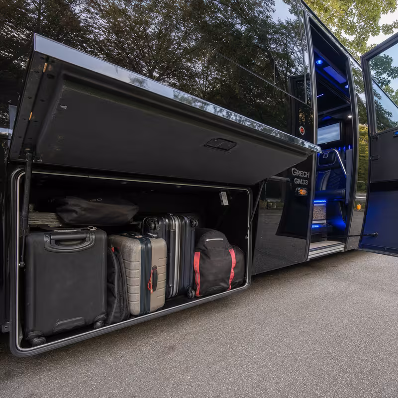 Party bus interior with wraparound leather seating and LED lighting in Dallas