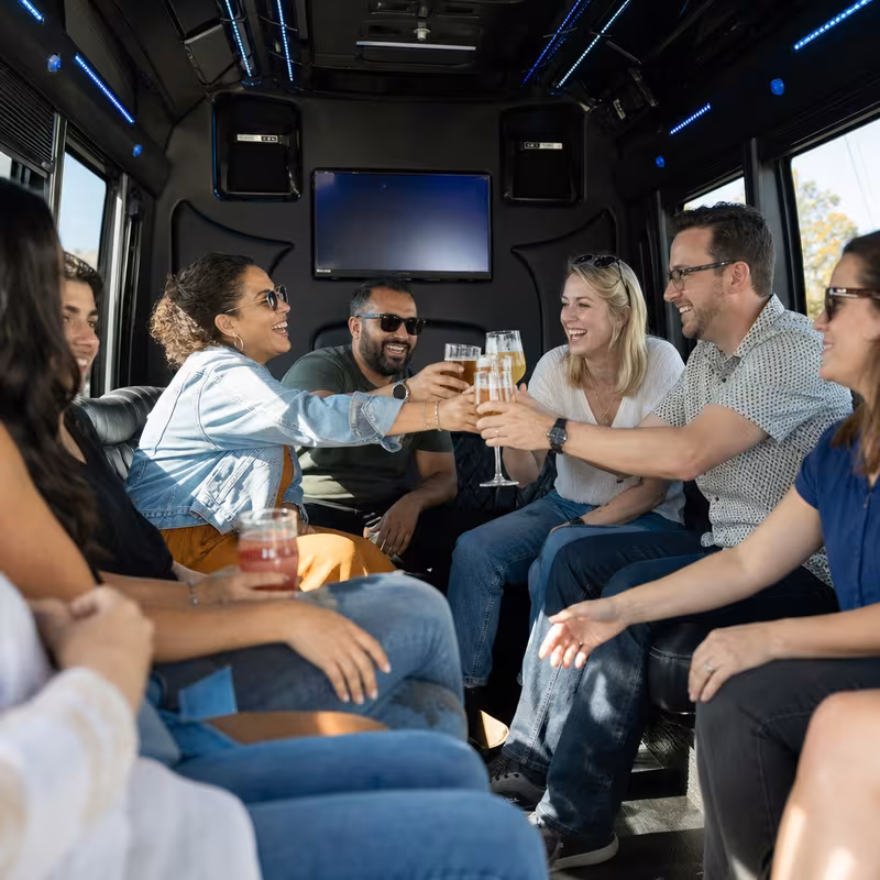 Group boarding a white charter bus for Winery & Brewery Tour Transportation transportation in Dallas
